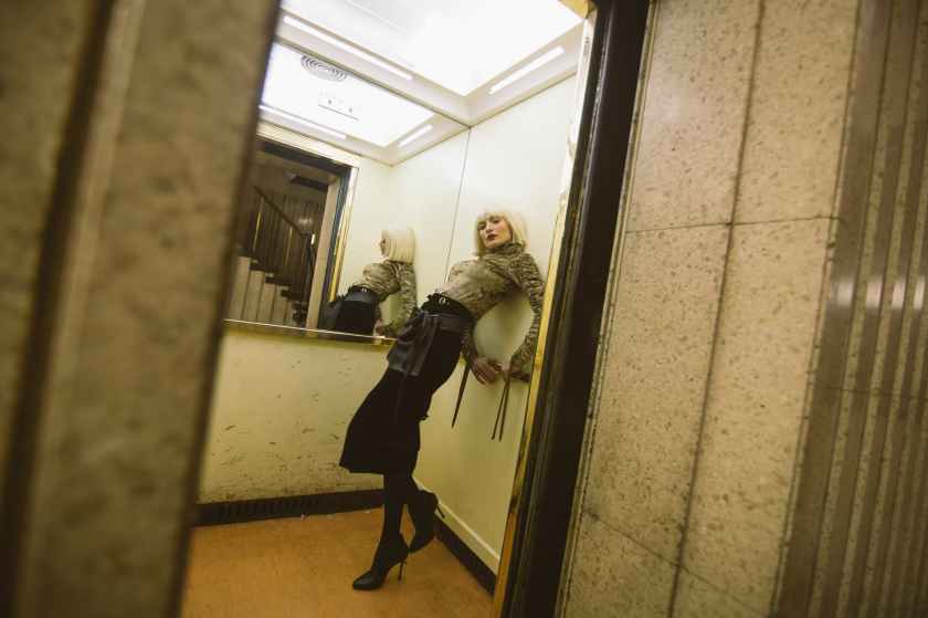 photography of a woman on elevator